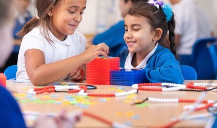Two girls using maths resources to count